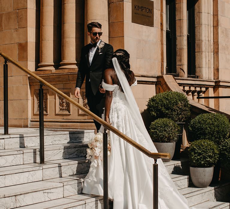 Bride and groom walking up the stairs at the Kimpton Fitzroy London wedding 