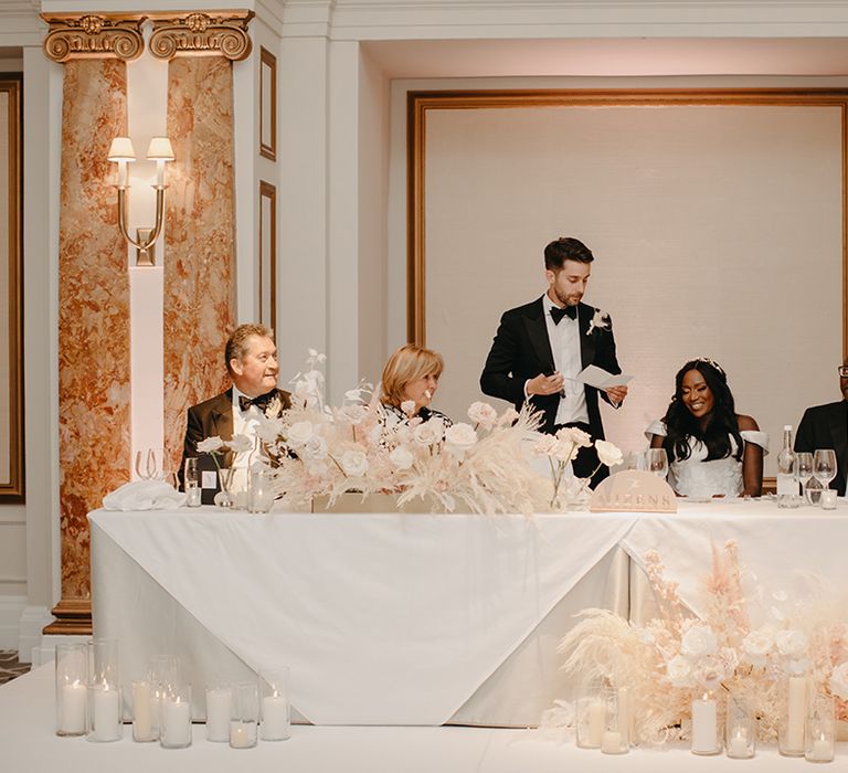 The groom stands to perform his wedding speech 