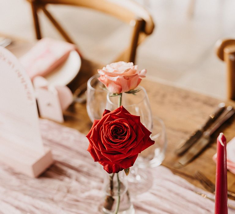 Red rose in bud vases for romantic table decor at Valentine's wedding theme 