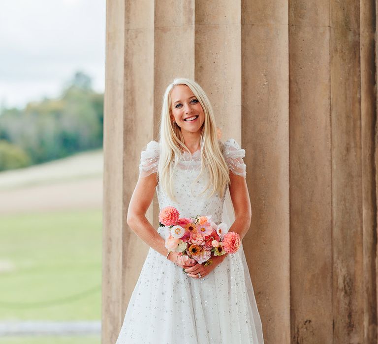 Bride in sparkly princess wedding dress from Jenny Packham with pink wedding bouquet