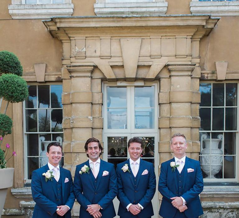 Groomsmen in navy three piece wedding suits for luxe country house wedding 