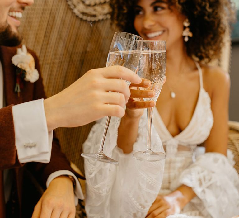 The bride and groom cheers together and make a toast at their wedding 