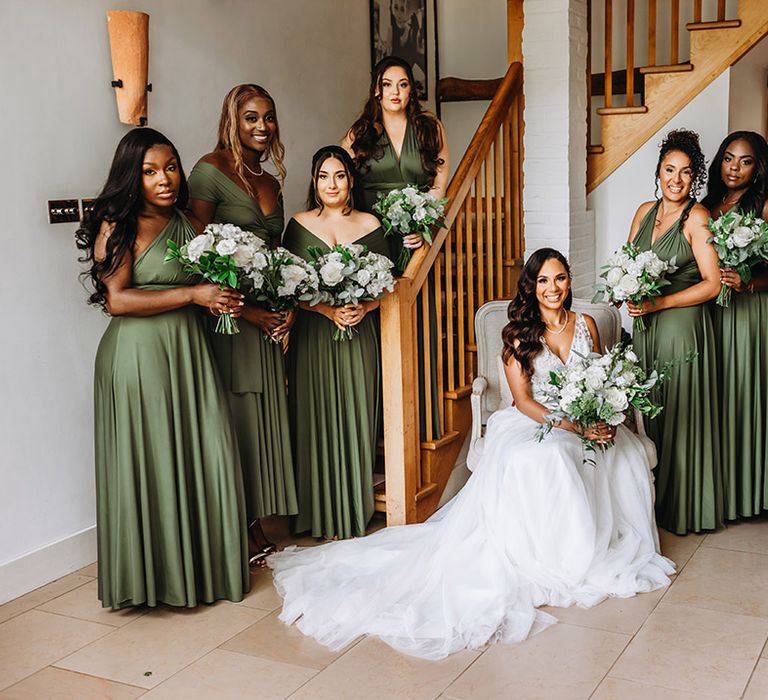 Bridal party wearing dark green bridesmaid dresses 