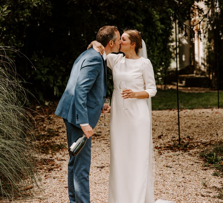 Bride and groom steal a kiss