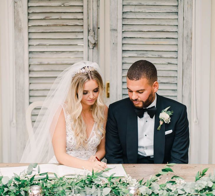 Bride and groom signing the register