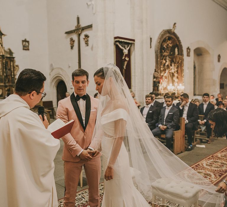 Bride and groom exchanging vows at Spanish church wedding