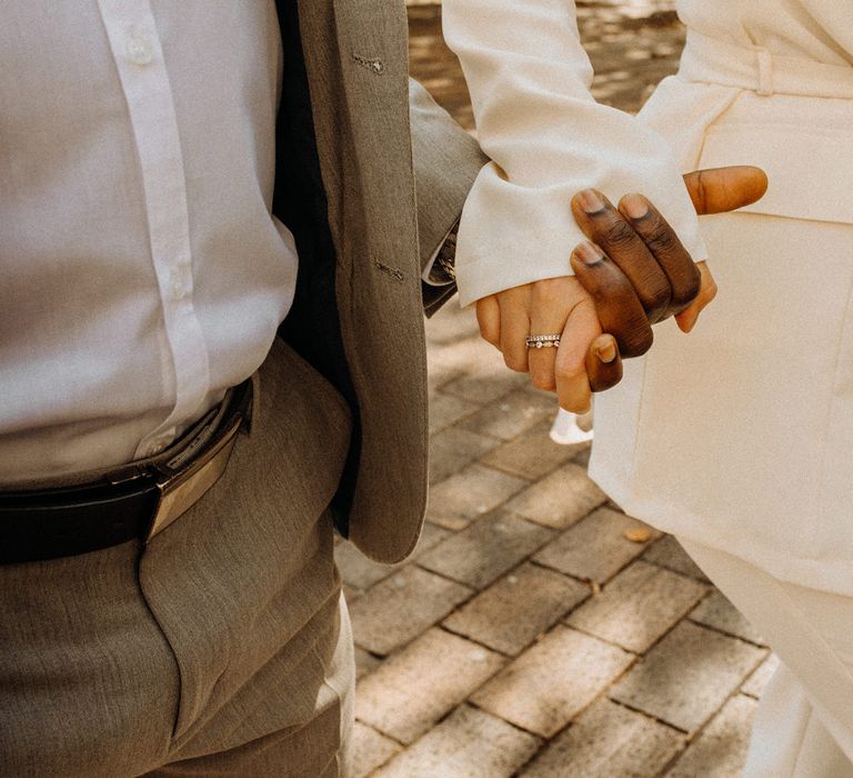 Bride and groom holding hands at Portsmouth Guidhall city elopement 