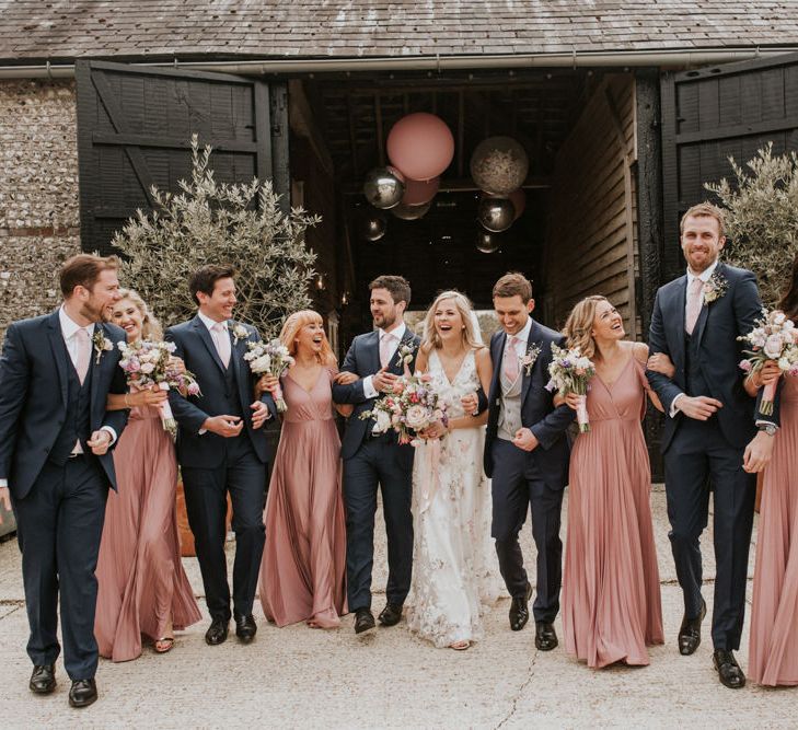 Wedding party portrait in pink and navy outfits 