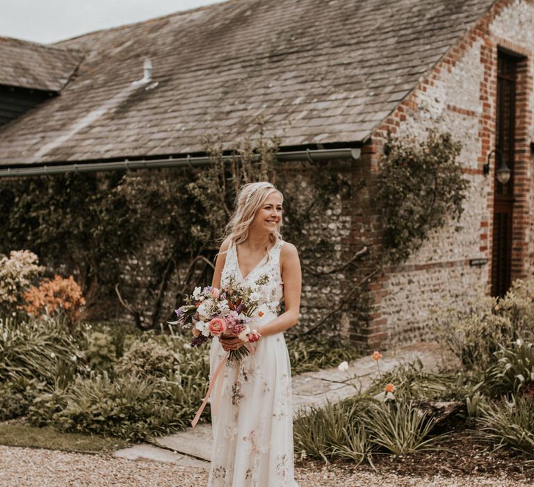 Bride in pink and white floral embroidered wedding dress