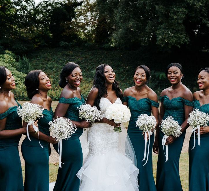 Black bride with her bridesmaids in green dresses