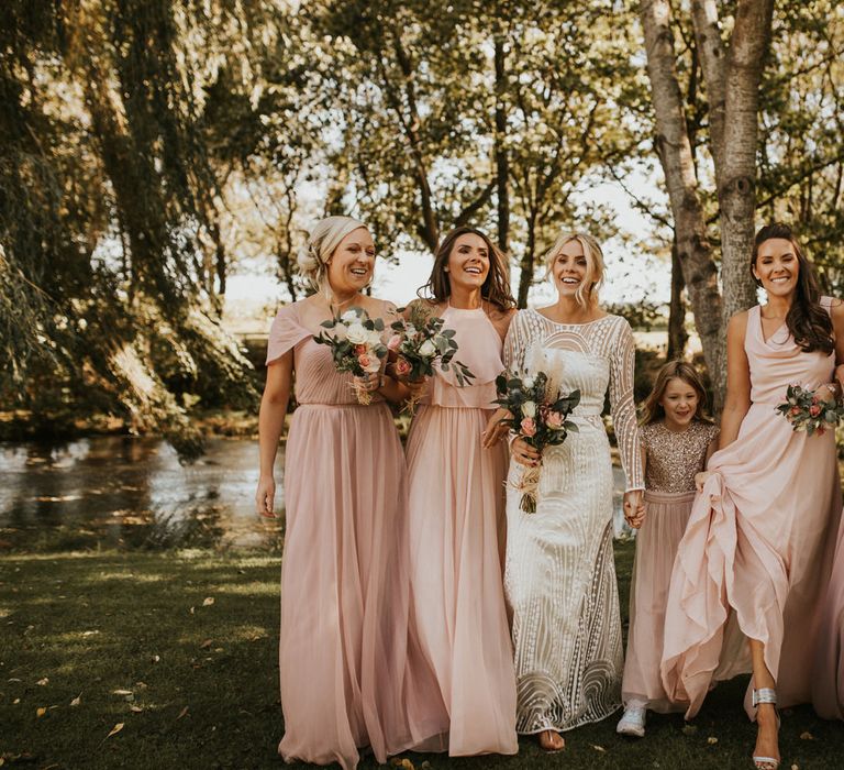 Bridal party portrait with bridesmaids in pink TH&TH dresses and bride in preloved wedding dress