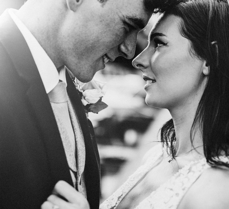 Bride & groom look at each other lovingly on wedding day 