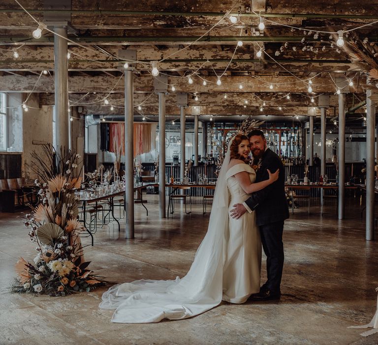 Micro wedding at Industrial wedding venue, Holmes Mill, with festoon lights and dried flowers 