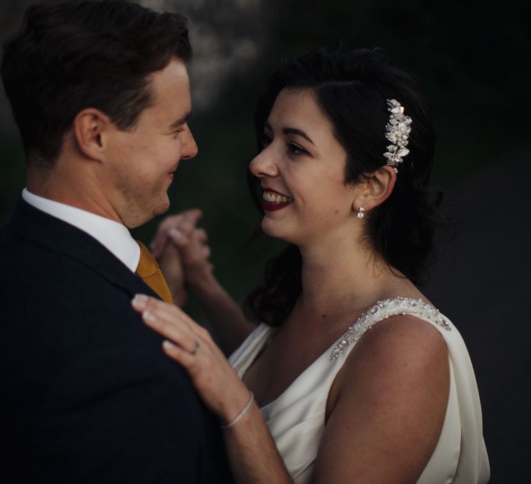 Bride & groom dance together outdoors