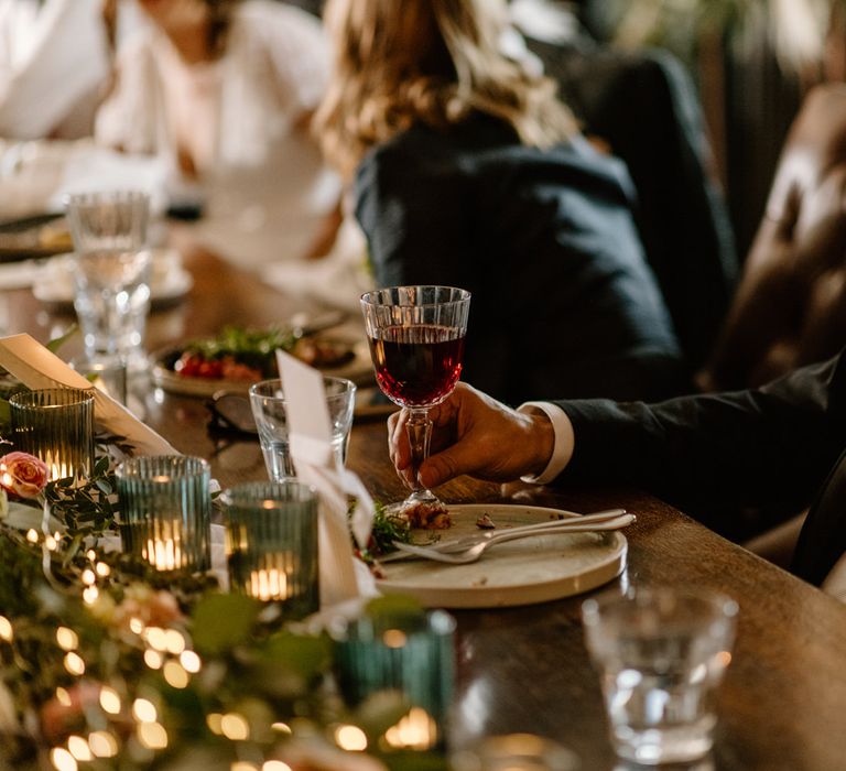 Wedding guest drinking red wine at no131 wedding venue