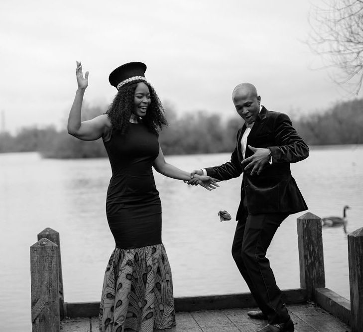 Black African bride and groom dancing on the dock 