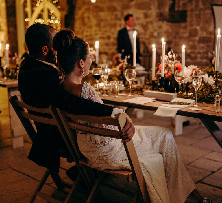 Wedding reception venue at night with lit candles and rustic styling