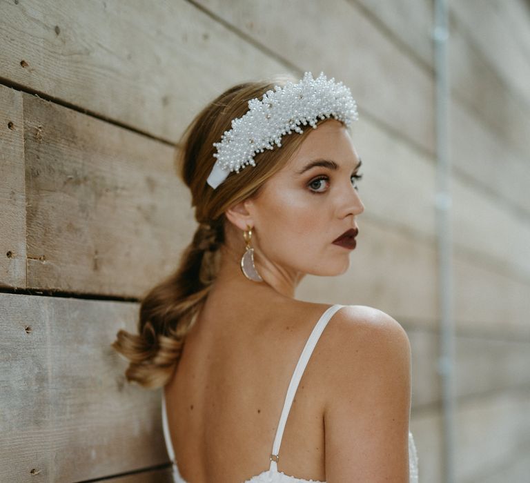 Pearl headband and dark lipstick 