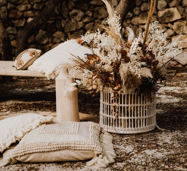 Wicker lampshades with bouquets of pampas grass in a white wicker basket