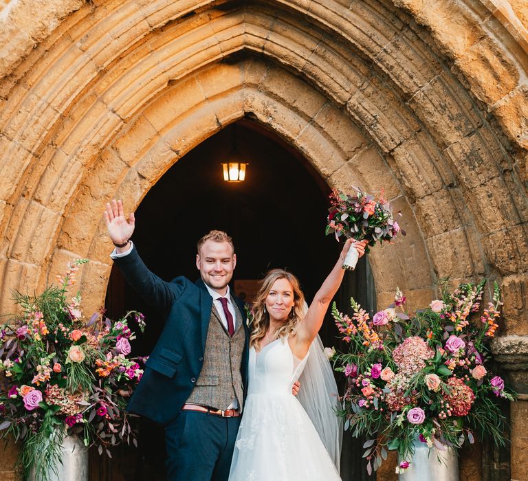 Bride & groom celebrate outside the church on their wedding day