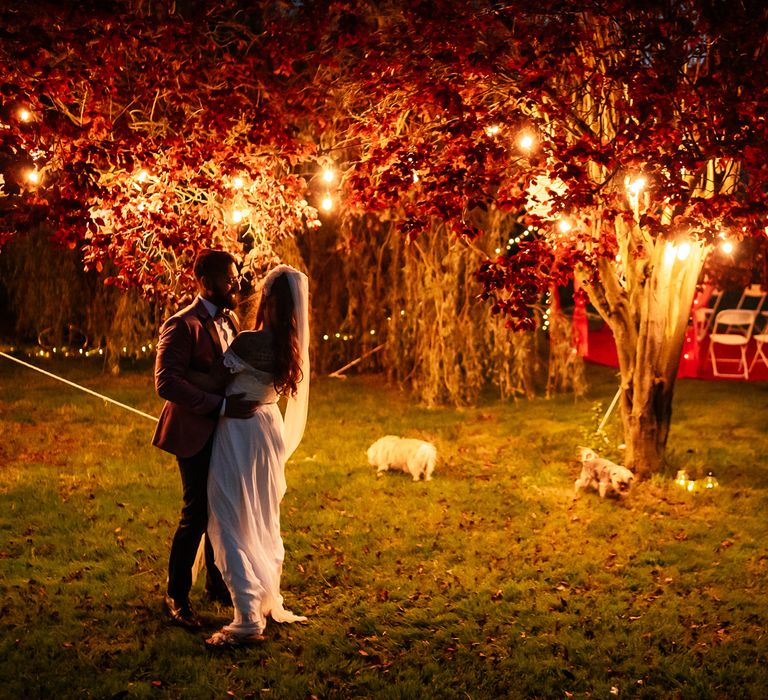 Outdoor garden wedding party with lights in the trees