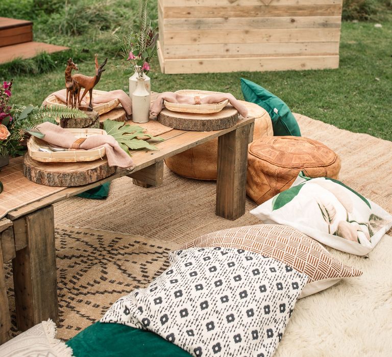 Safari inspired decor with wooden table and colourful pillows