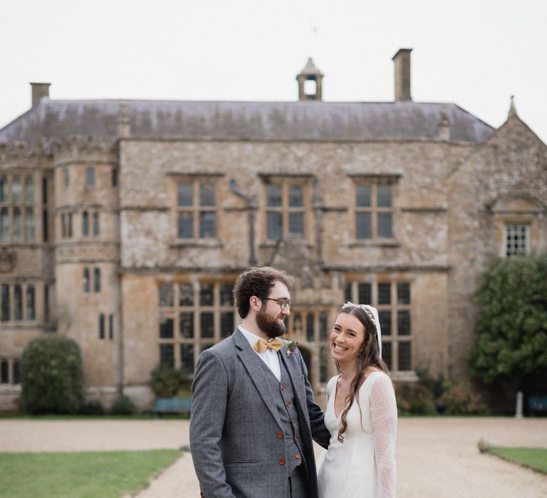 Bride and groom outside Brympton House on their wedding day 