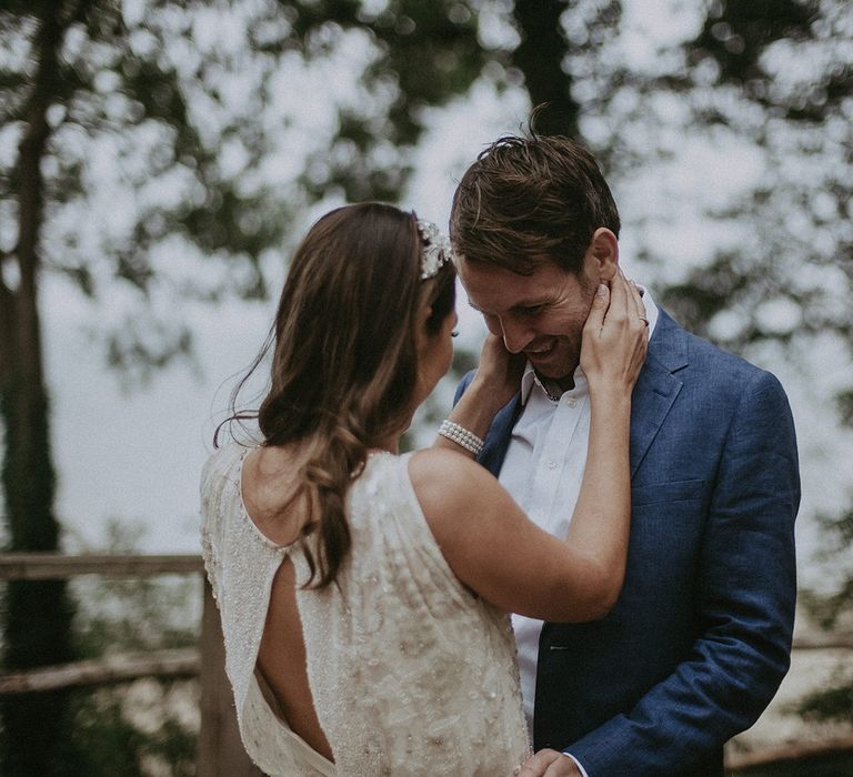 Bride wraps arms around grooms neck on their wedding day