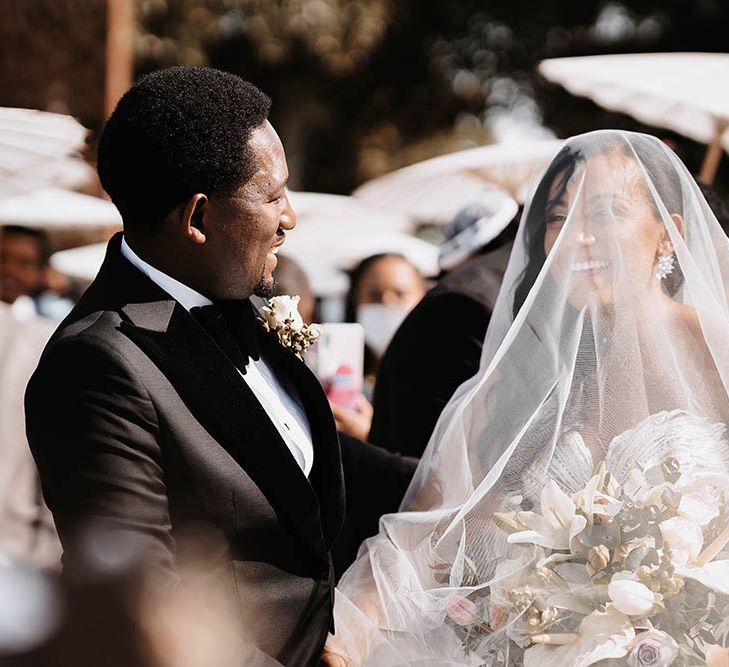 Wedding ceremony bridal entrance with her wedding veil over her face 