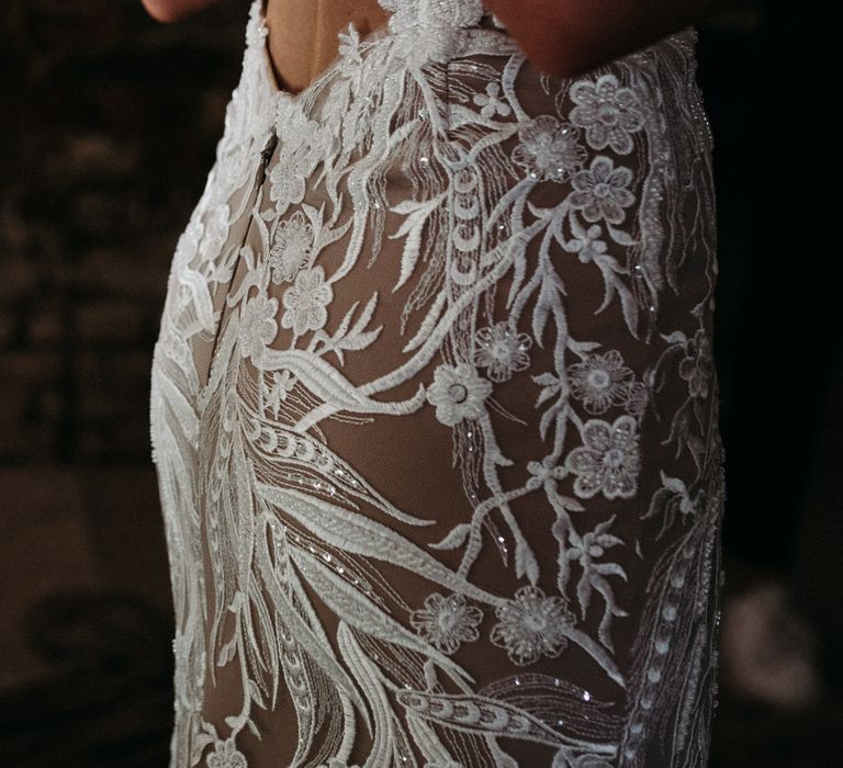 Embroidered wedding dress details in floral pattern with mesh under lining