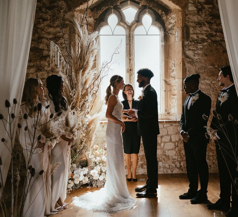 Intimate humanist wedding ceremony at Pentney Abbey with dried and fresh flower arrangements 