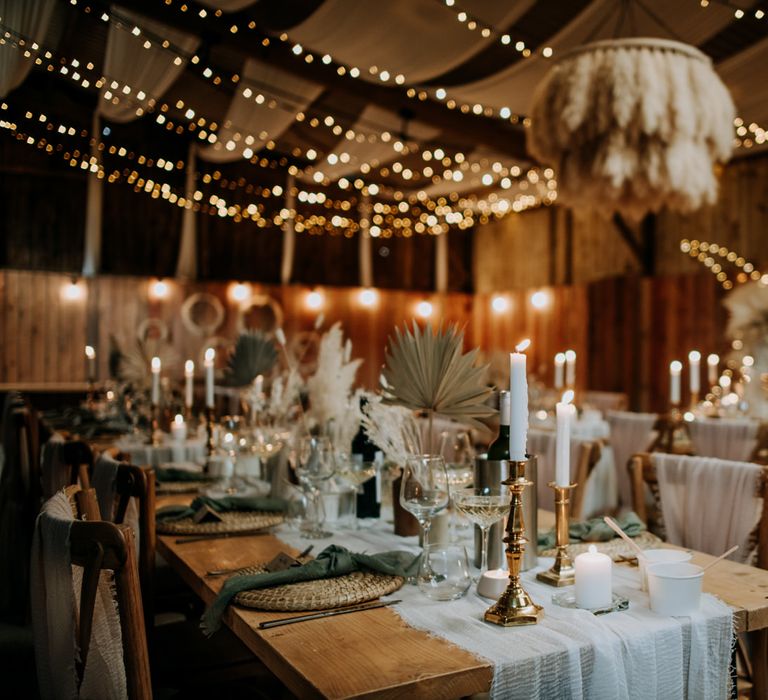 Bohemian wedding reception decor at East Yorkshire Barns with pampas grass chandelier, gold candlesticks and fairy lights 