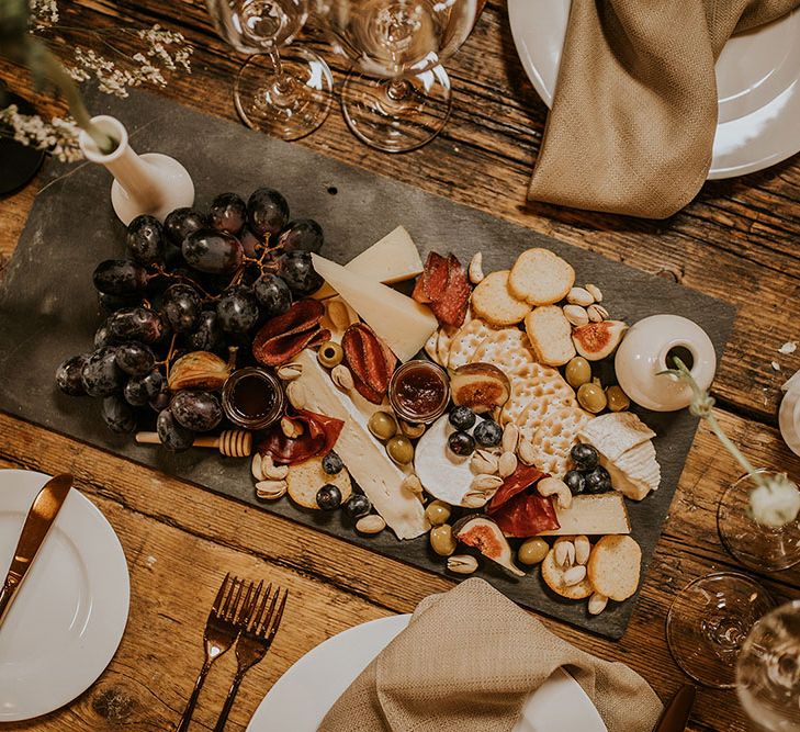 Grazing board with cheese, crackers, grapes and figs