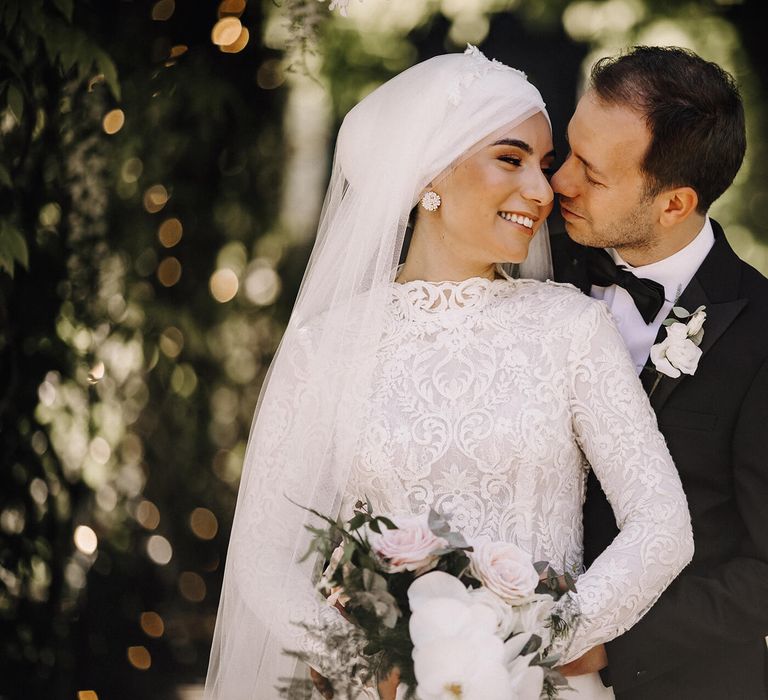 Groom embracing bride in glorious nature setting