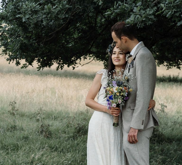 Bride & groom hug one another outdoors on their wedding day