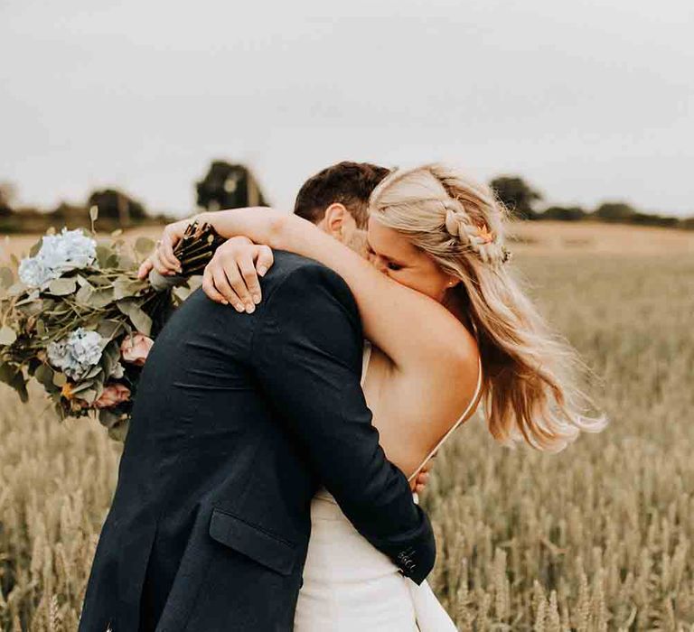 Bride and groom share a moment at rustic wedding with DIY garden games