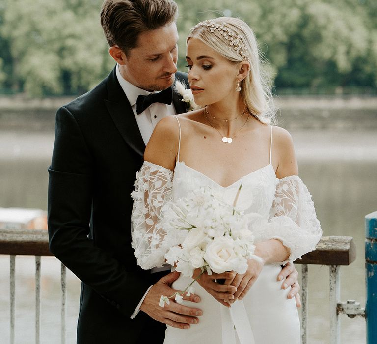 Black tie city wedding in Putney with bride and groom in a tuxedo and satin and lace wedding dress with detachable sleeves 