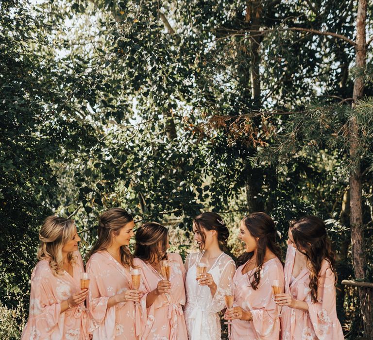 Bride & Bridal party in their blush pink floral bridal robes 