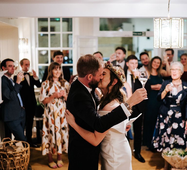 Bride & groom kiss during wedding reception dance