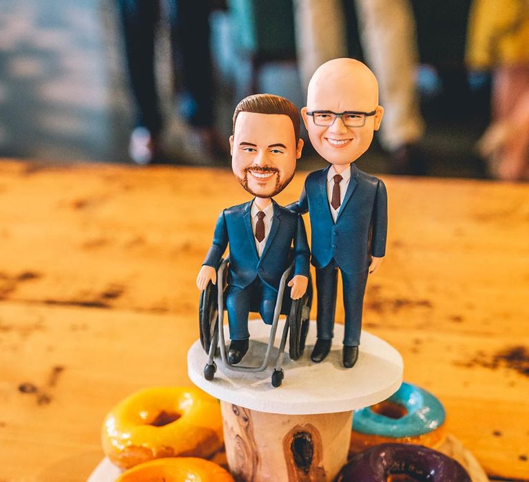 Groom cake toppers on bright doughnuts