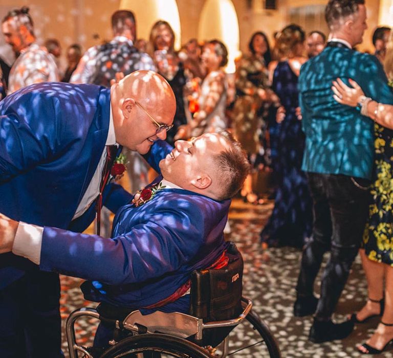 Grooms enjoy dance floor at industrial wedding venue