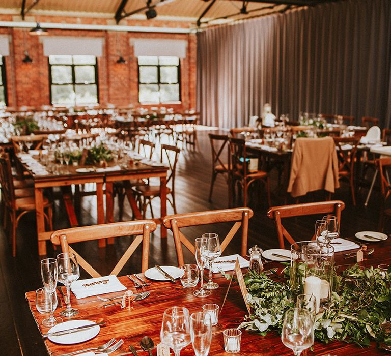 Rustic wedding venue reception complete with wooden tables 