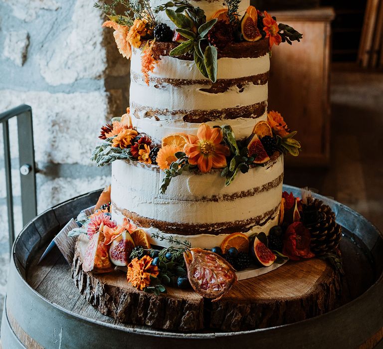 Rustic 3-tier wedding cake complete with naked icing and Autumnal floral decor 