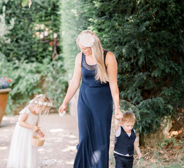 Wedding guest walks with children outdoors 