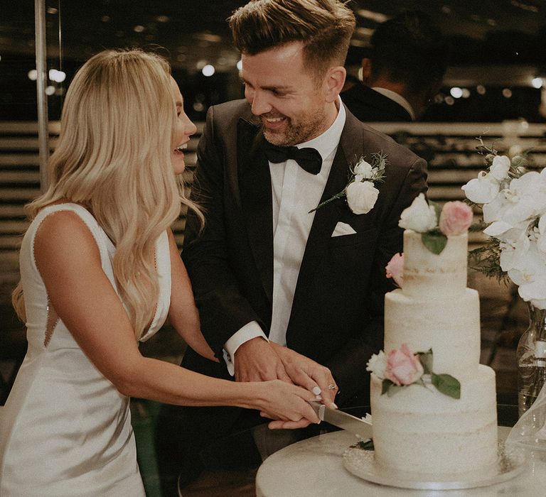 Bride and groom cut their wedding cake