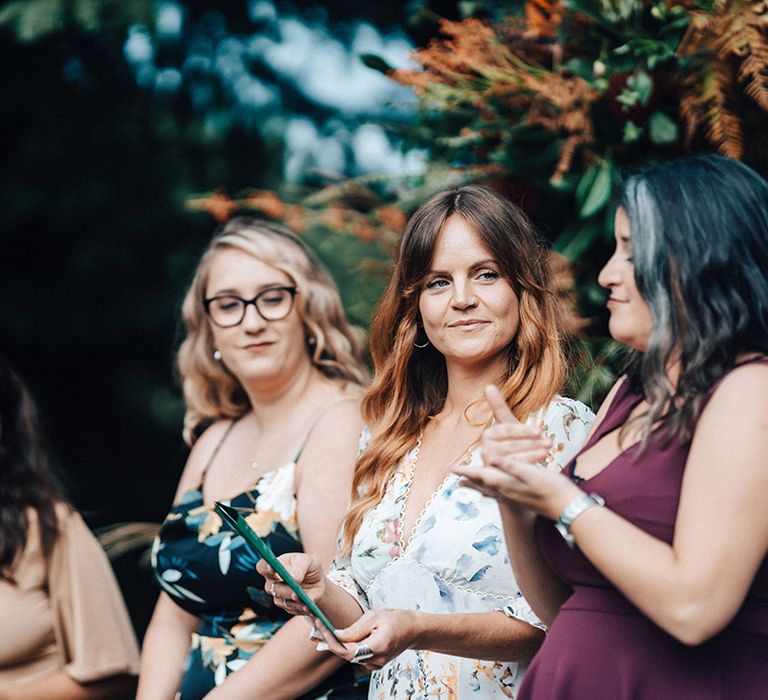 Wedding guests particpate in sign language wedding ceremony for deaf couple