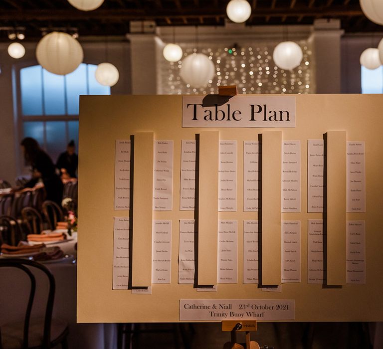 Yellow card seating chart for industrial wedding at Trinity Buoy Wharf