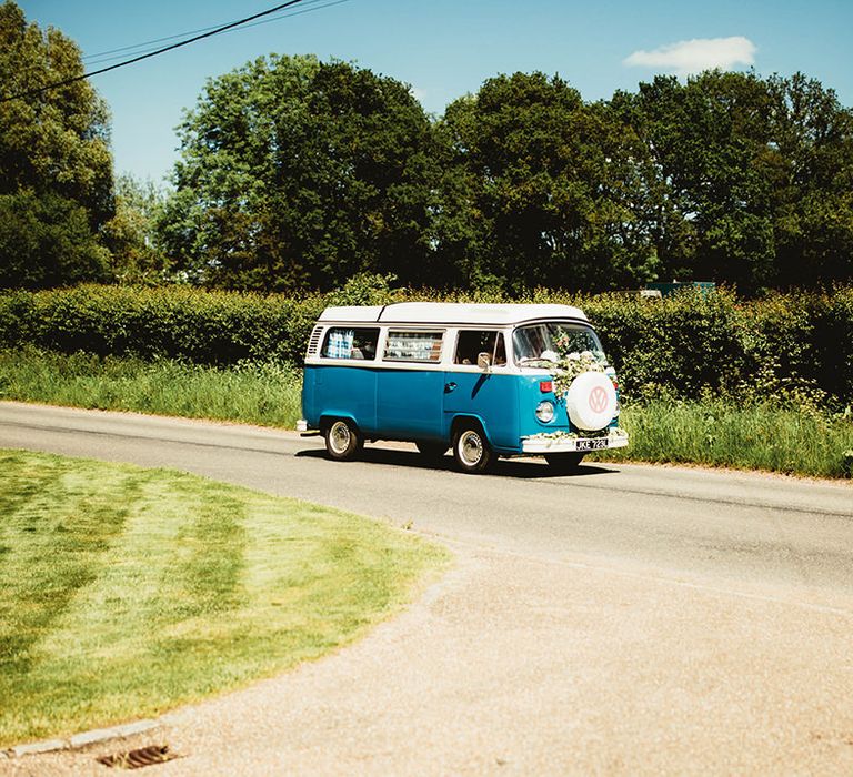 Vintage Volkswagen camper decorated with flowers for wedding car transportation