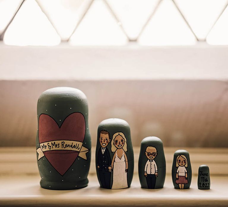 Matryoshka style dolls handprinted to represent the newlyweds and their children 