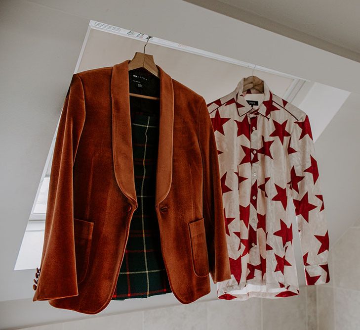 Orange velvet blazer next to colourful white and red star shirt 